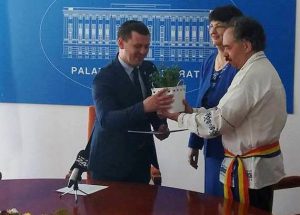 The "Forget-me-not" flower is handed over by Mircea-Valer Pauca, a person with High-functioning autism